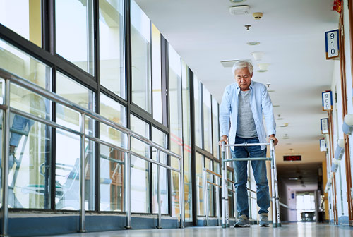 Elderly Patient Walking Through Healthcare Facility