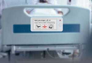 e-ink display with hospital bed in the background